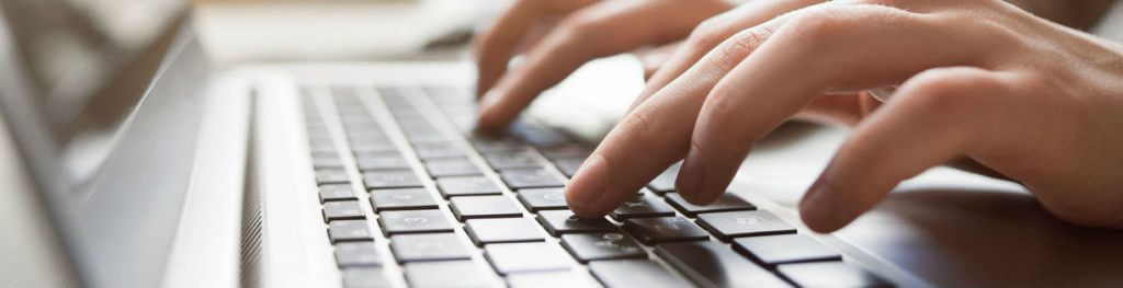 Person typing on keyboard